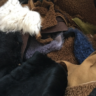 Vilniaus Kailiai Kailio atraižos pelts and hides with soft, natural textures and neutral tones, suitable for crafts or fashion accessories.