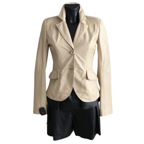 Beige color short sheep leather jacket with notched lapels on a mannequin.