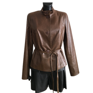 A brown sheep leather belted short jacket with buttons, displayed on a mannequin wearing a dark outfit.
