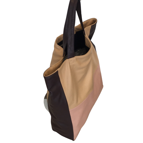 A tricolor tote bag with eggplant, beige, and light rose colors, made of soft leather with a water-resistant lining, featuring two shoulder straps and a small inside pocket with zip closure.